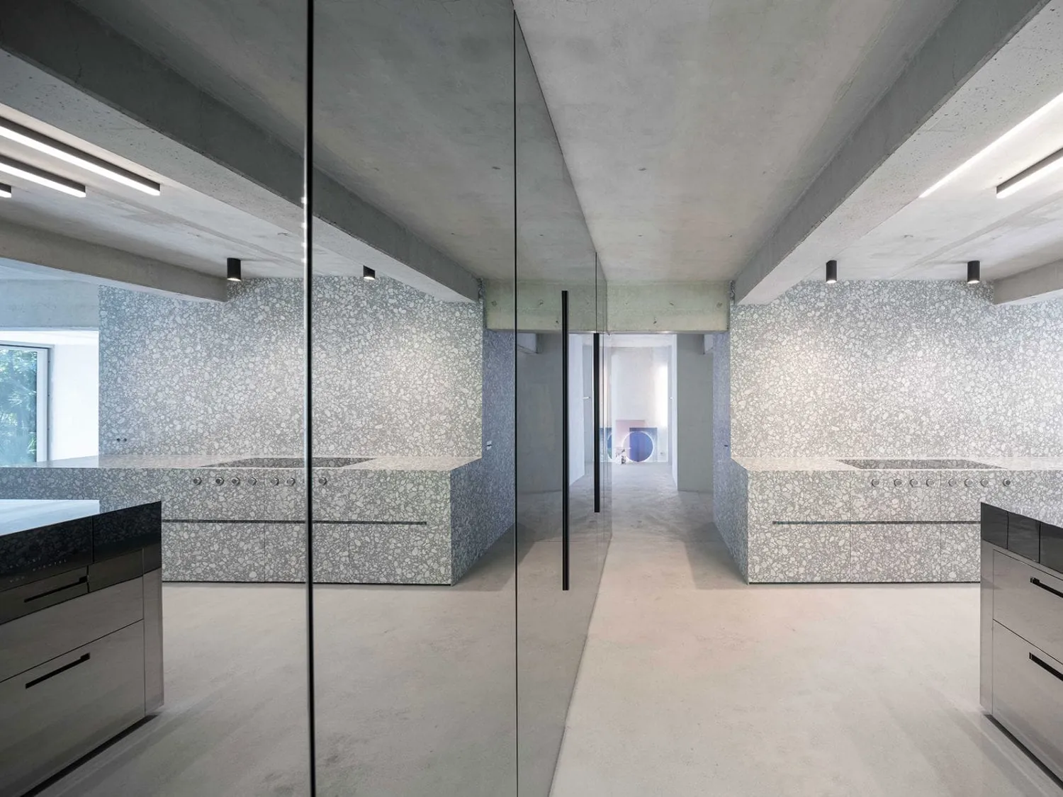 Modern industrial kitchen with concrete walls and floor.