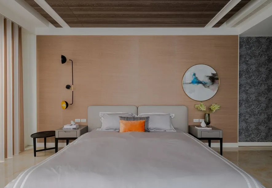 A modern minimalist bedroom featuring neutral tones, a stylish bed with a headboard, and sleek, functional nightstands.