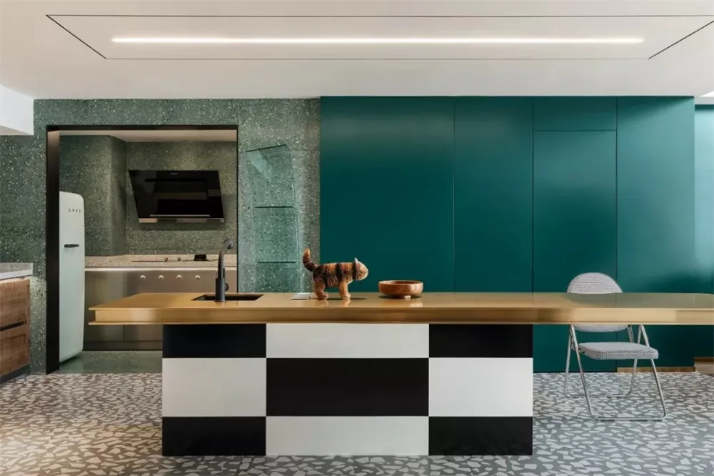 A modern residential kitchen featuring a terrazzo kitchen counter top, black and white checkered bottom cabinets, and a green