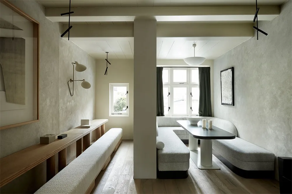 Modern restaurant interior with concrete, wood, and leather materials