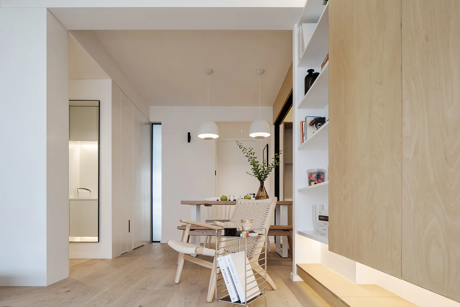 A modern minimalist dining room featuring wood and concrete materials.