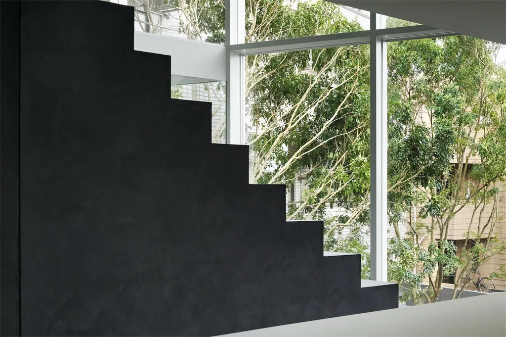 A modern, minimalist staircase made of concrete, featuring industrial design elements and a contemporary aesthetic, with view