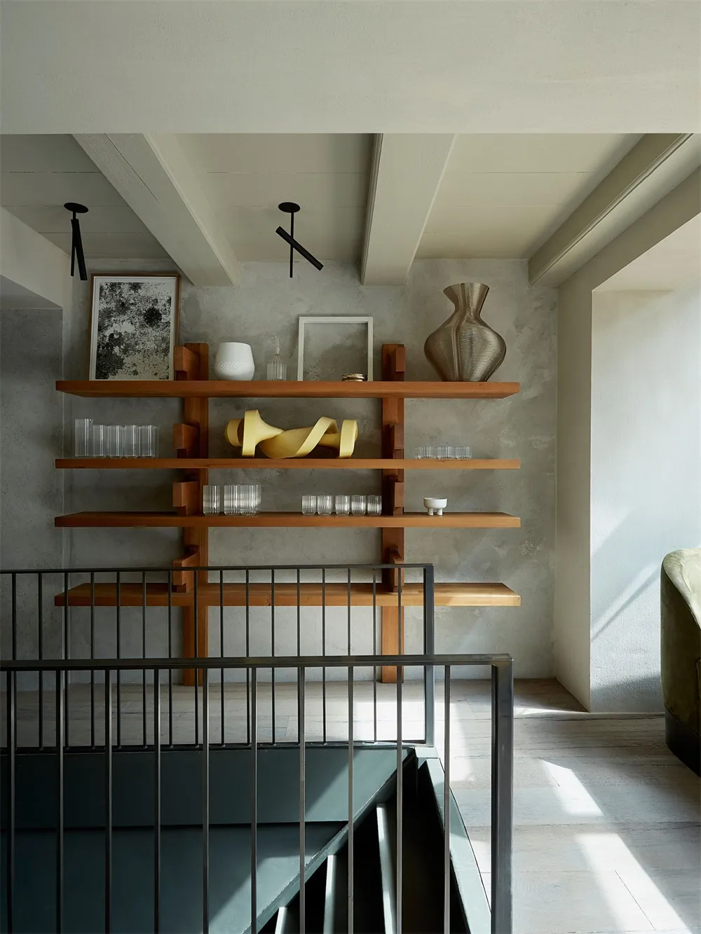 Modern interior design featuring wooden shelves against a concrete wall.