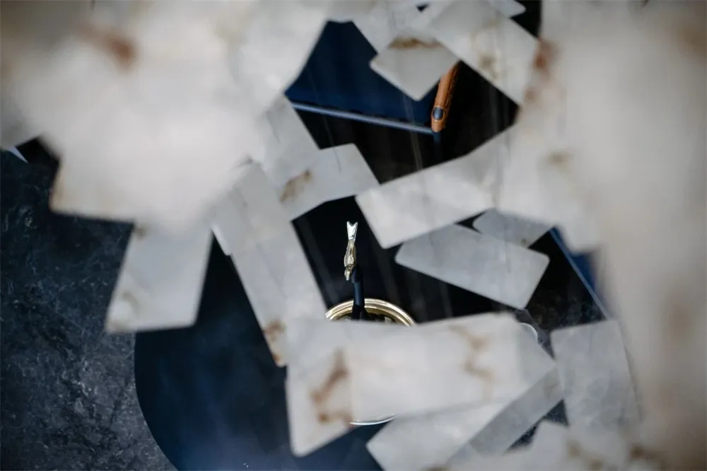 A vase made of white marble with black veins and gold accents