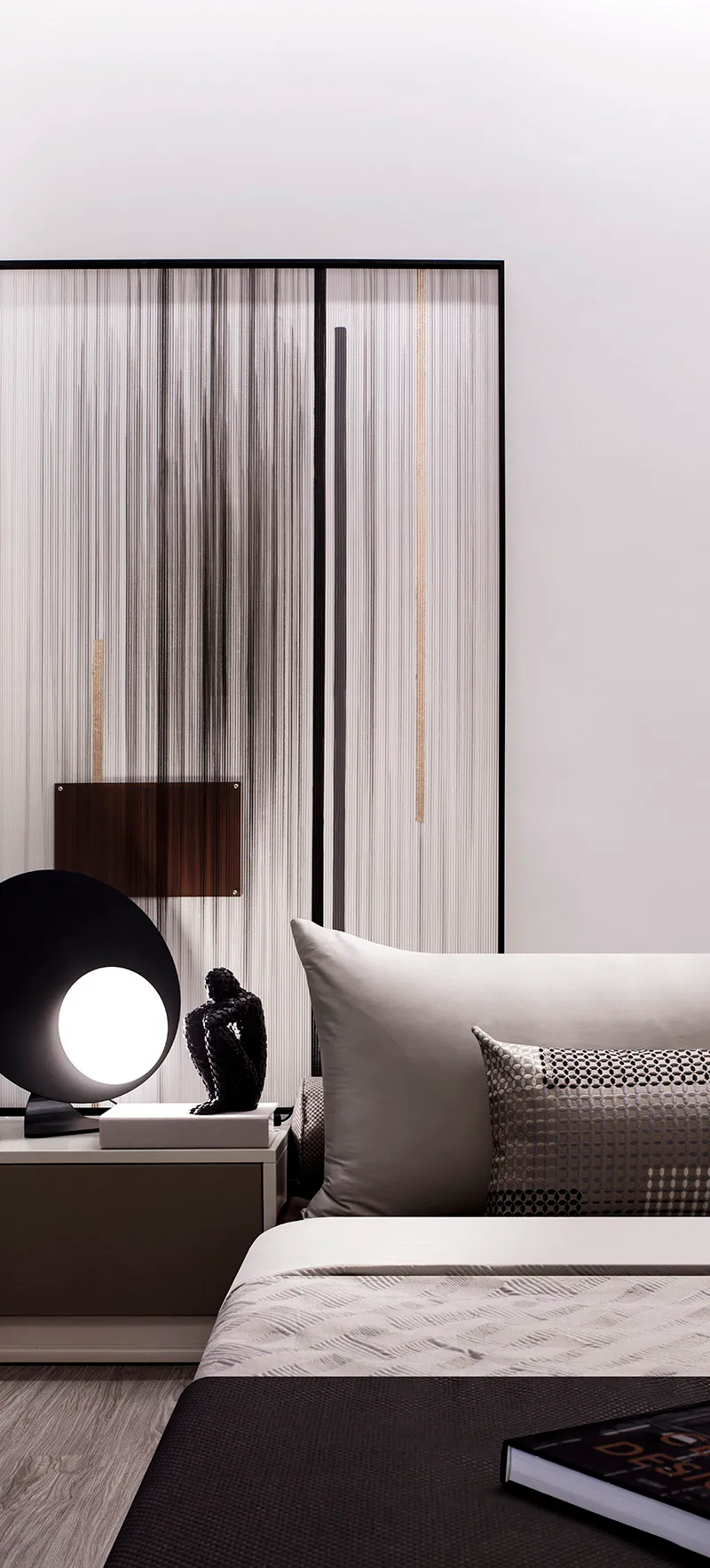A minimalist bedroom with a glass partition and fabric elements.