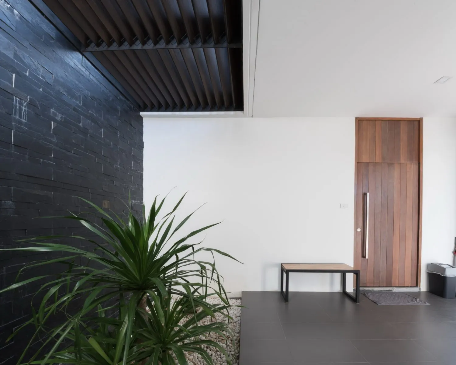 Contemporary entryway with concrete and wood finishes.