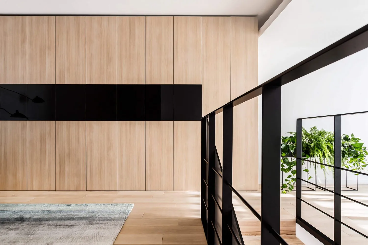 A modern living room featuring wooden paneling on the walls.