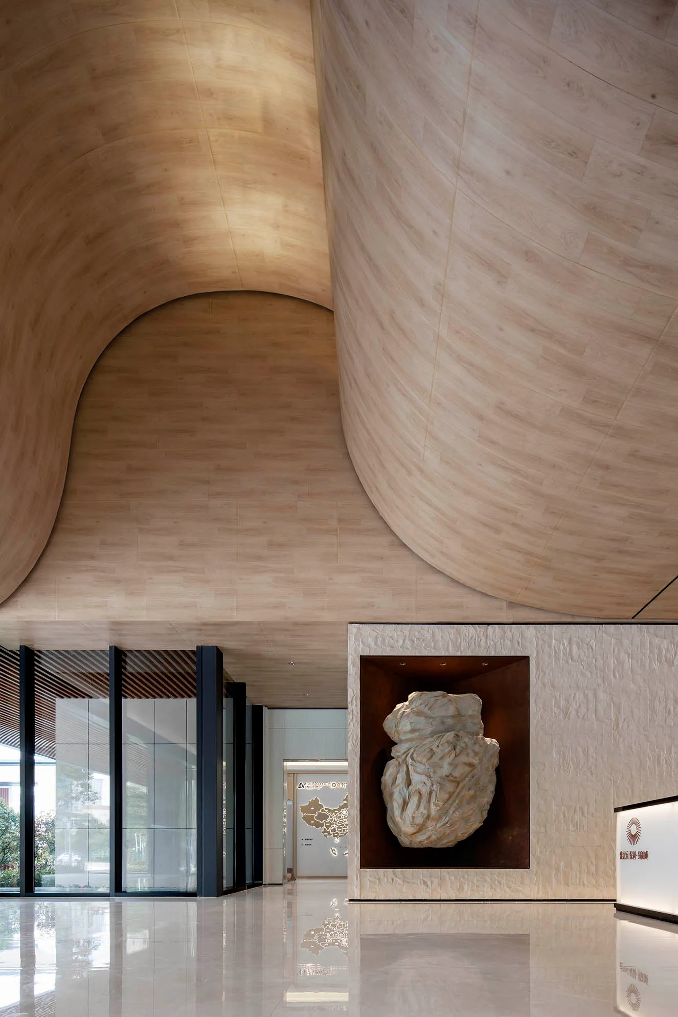 Modern lobby area with marble walls and a metal sculpture
