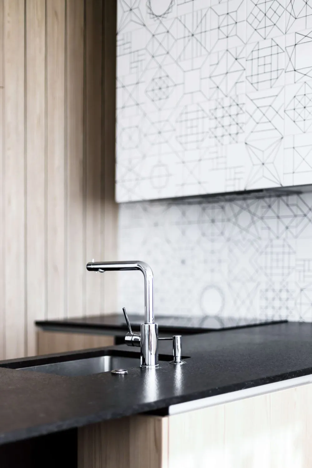 Modern minimalist kitchen featuring a metal countertop and sink.