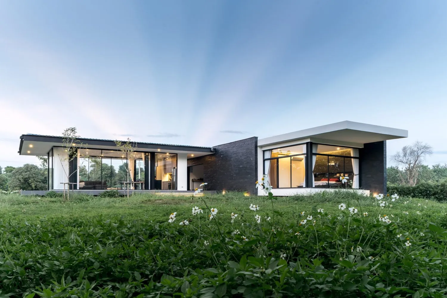 Modern home with glass walls, concrete and metal exterior
