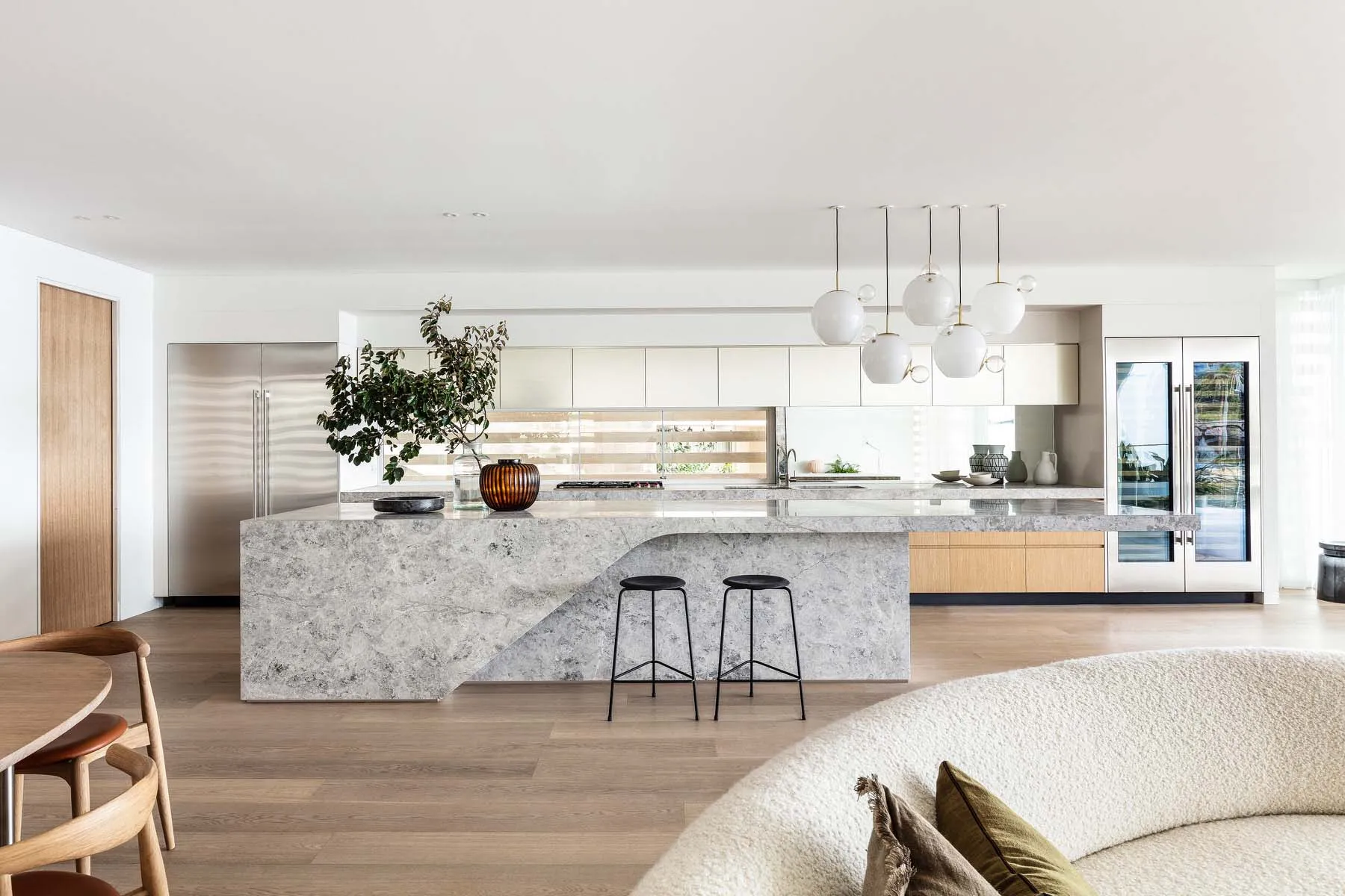 A modern residential kitchen featuring a large marble island.