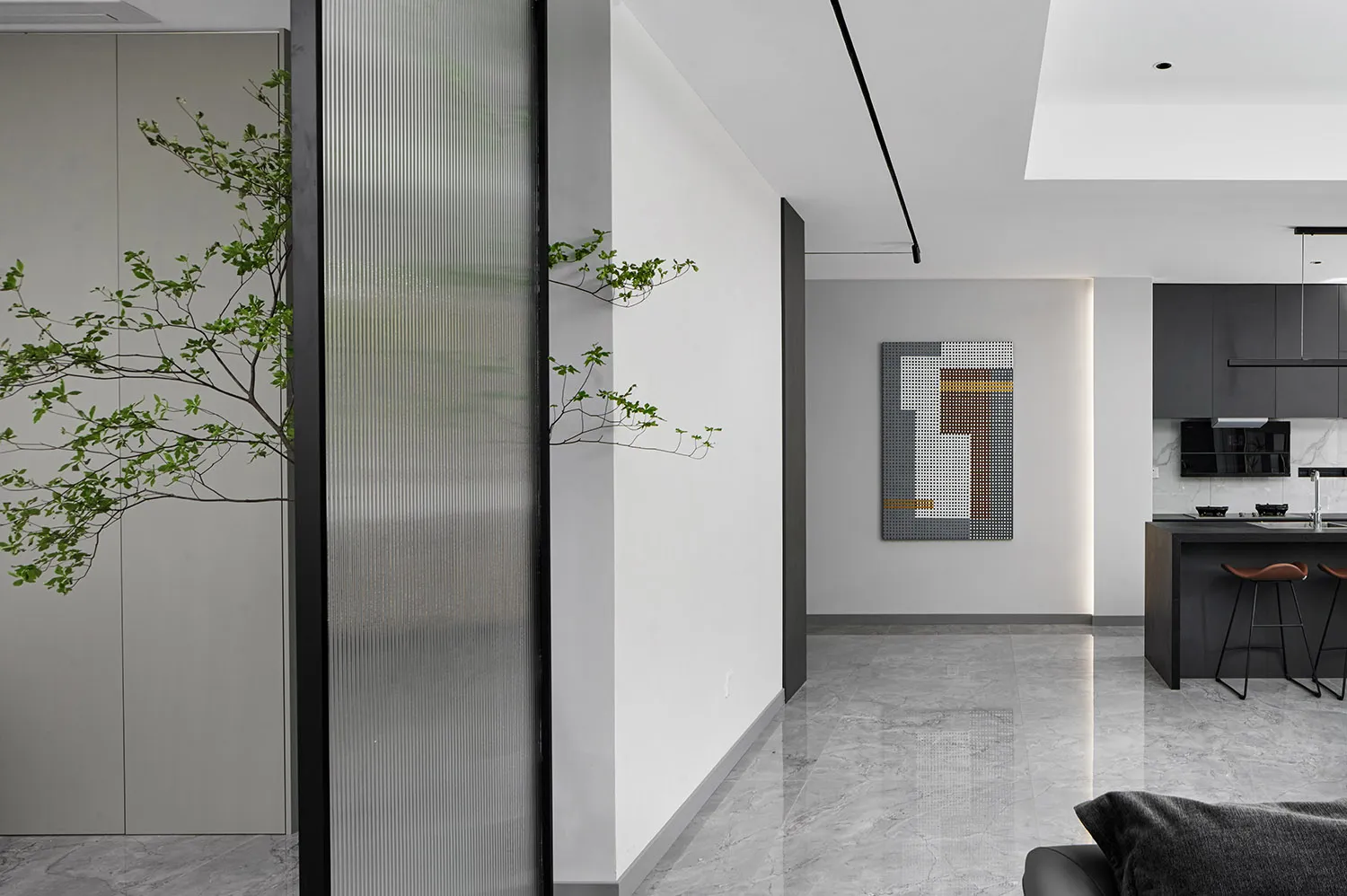Modern living room with glass panels and minimalist design.