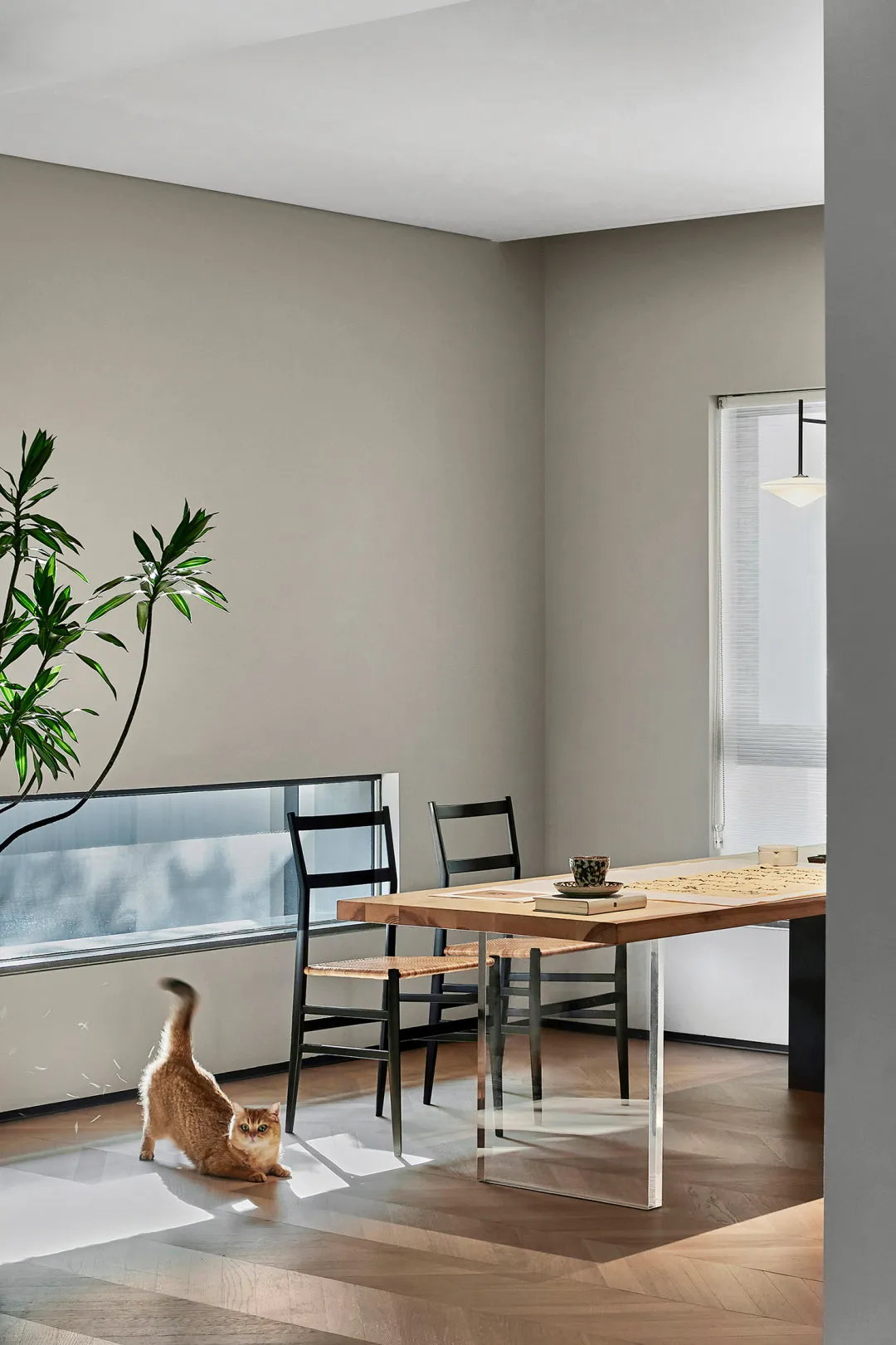 Modern living and dining room with wood, glass, and metal elements