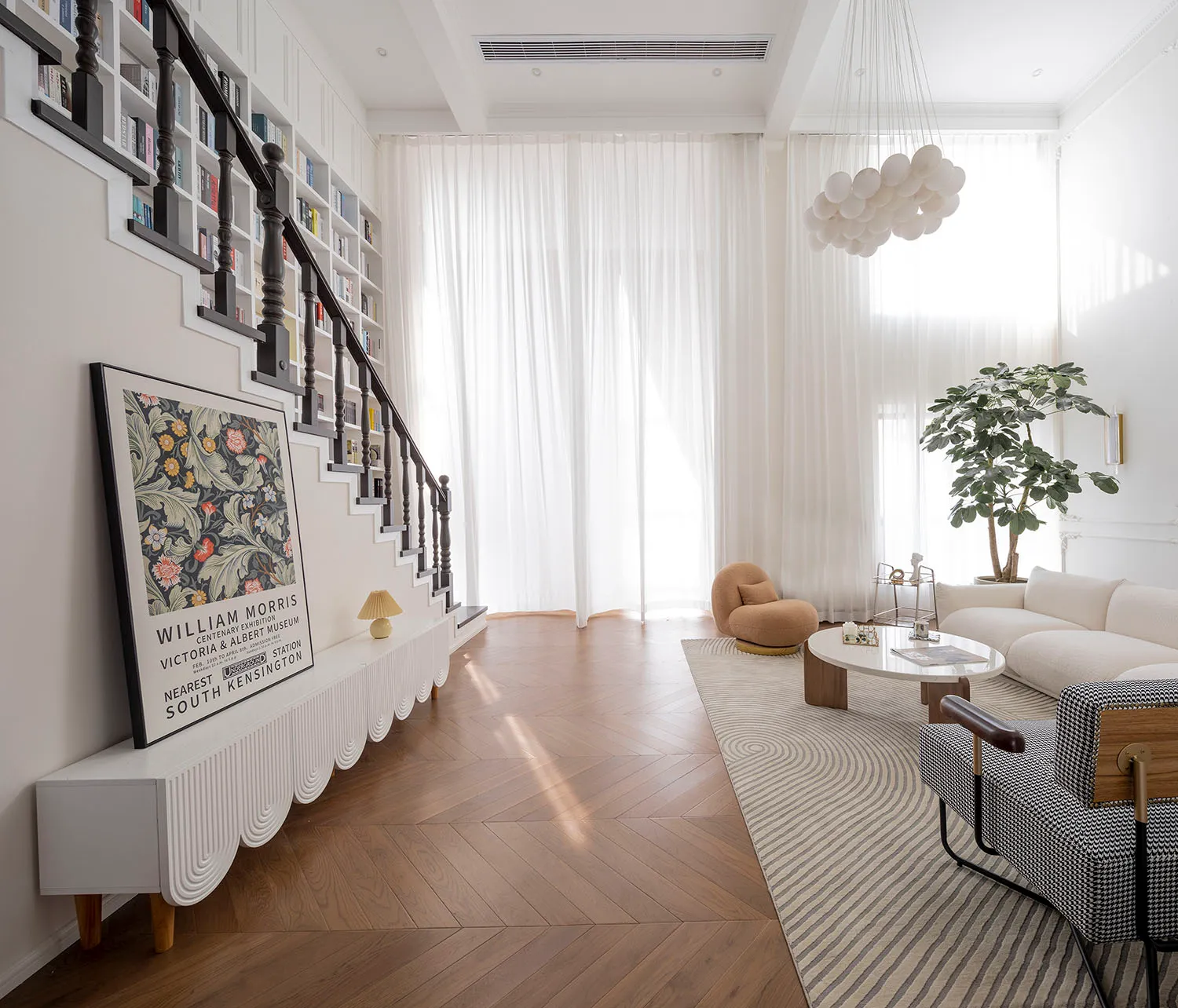 A modern living room featuring a herringbone-patterned floor and white curtains, creating a bright and spacious atmosphere.
