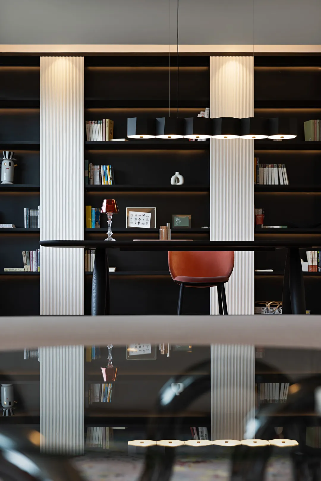A minimalist workspace with a polished wooden desk and metallic accents.