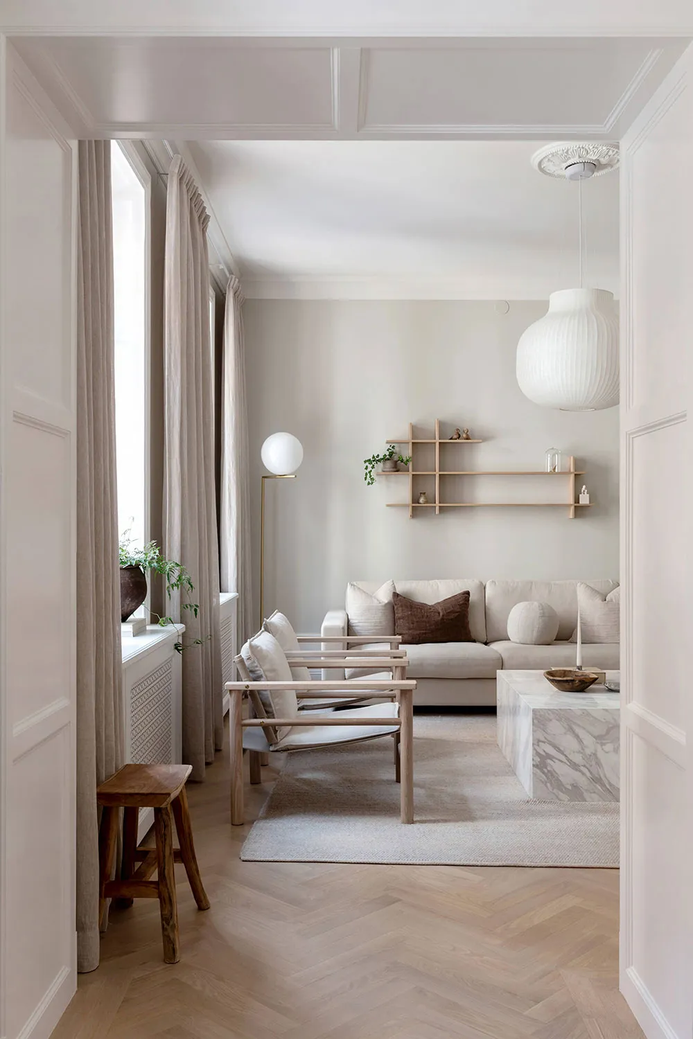 A minimalist living room featuring neutral-toned furniture and decor.