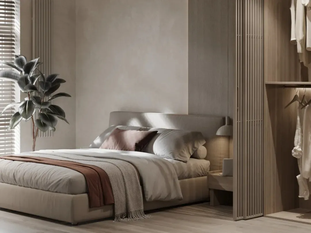 Modern bedroom featuring a comfortable bed with fabric bedding and pillows.