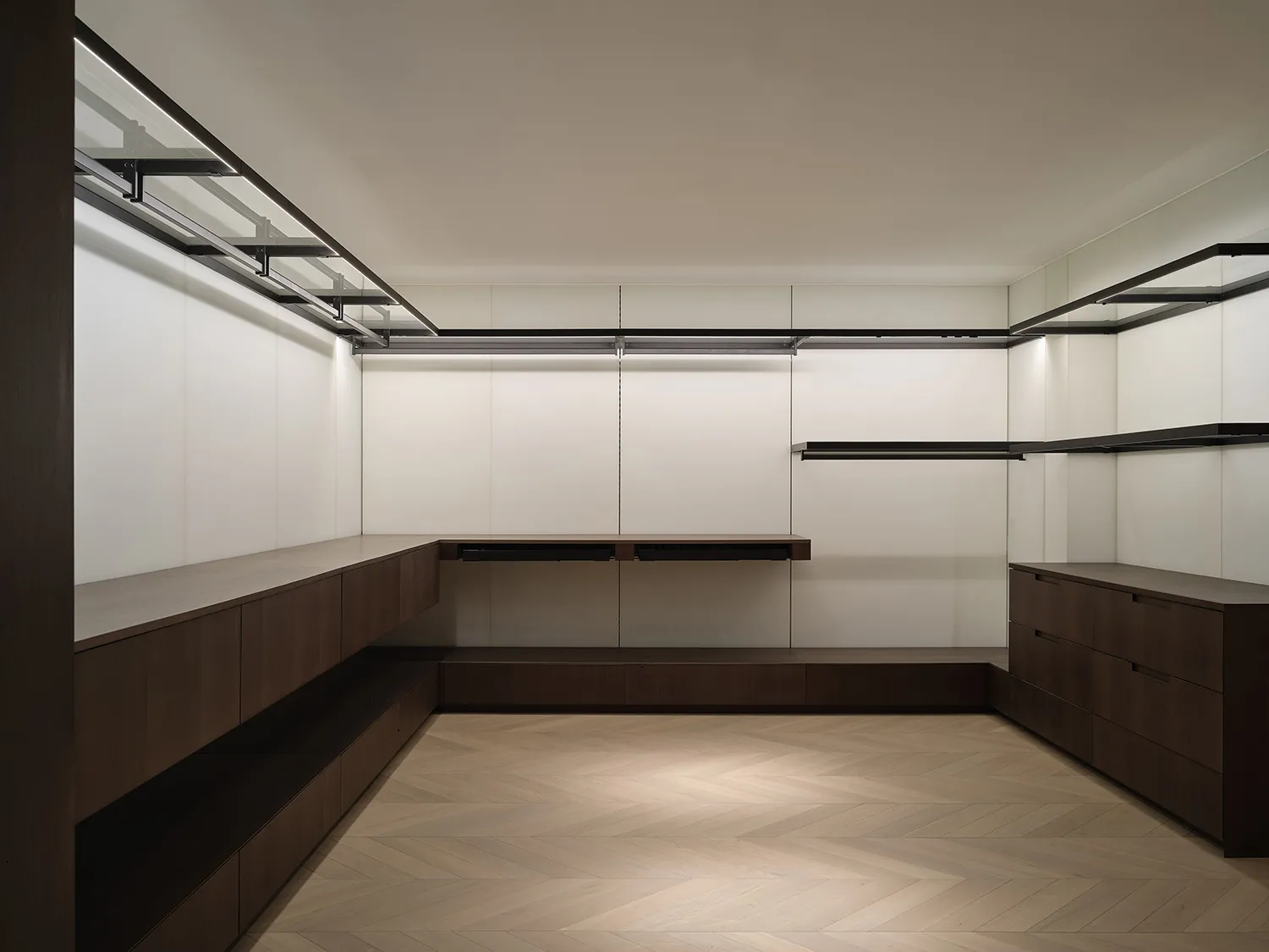 Modern closet with wooden cabinets and steel railings.