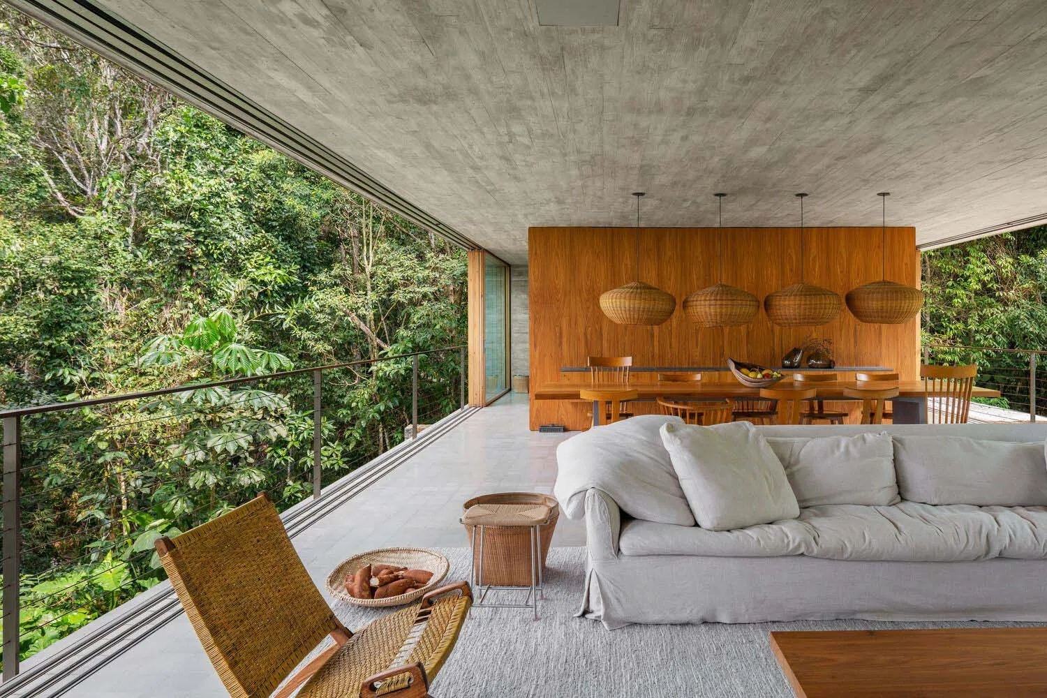 Modern interior design featuring a living room with concrete and wooden finishes.