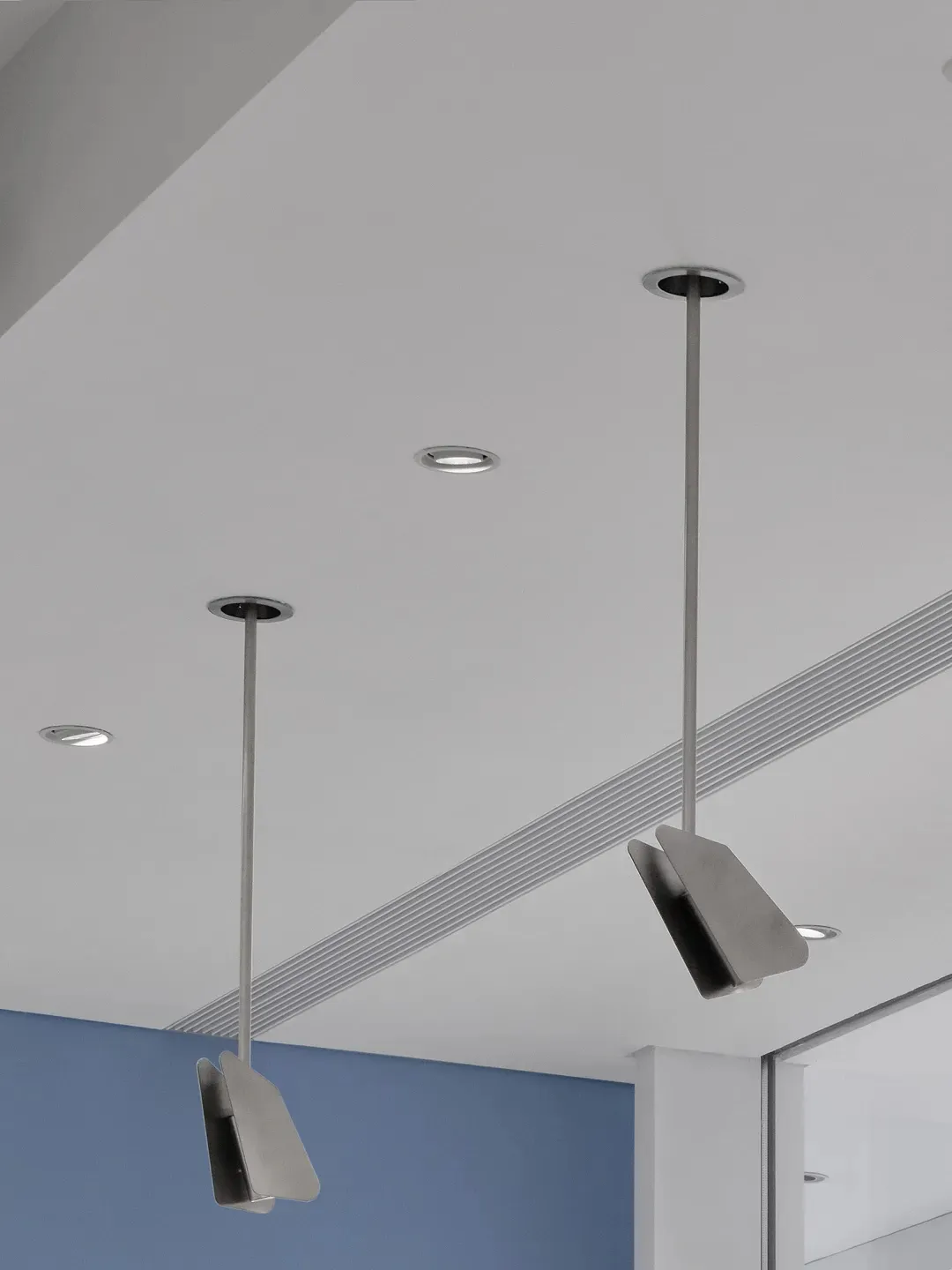A clean and minimalistic space with suspended lights as the main focus