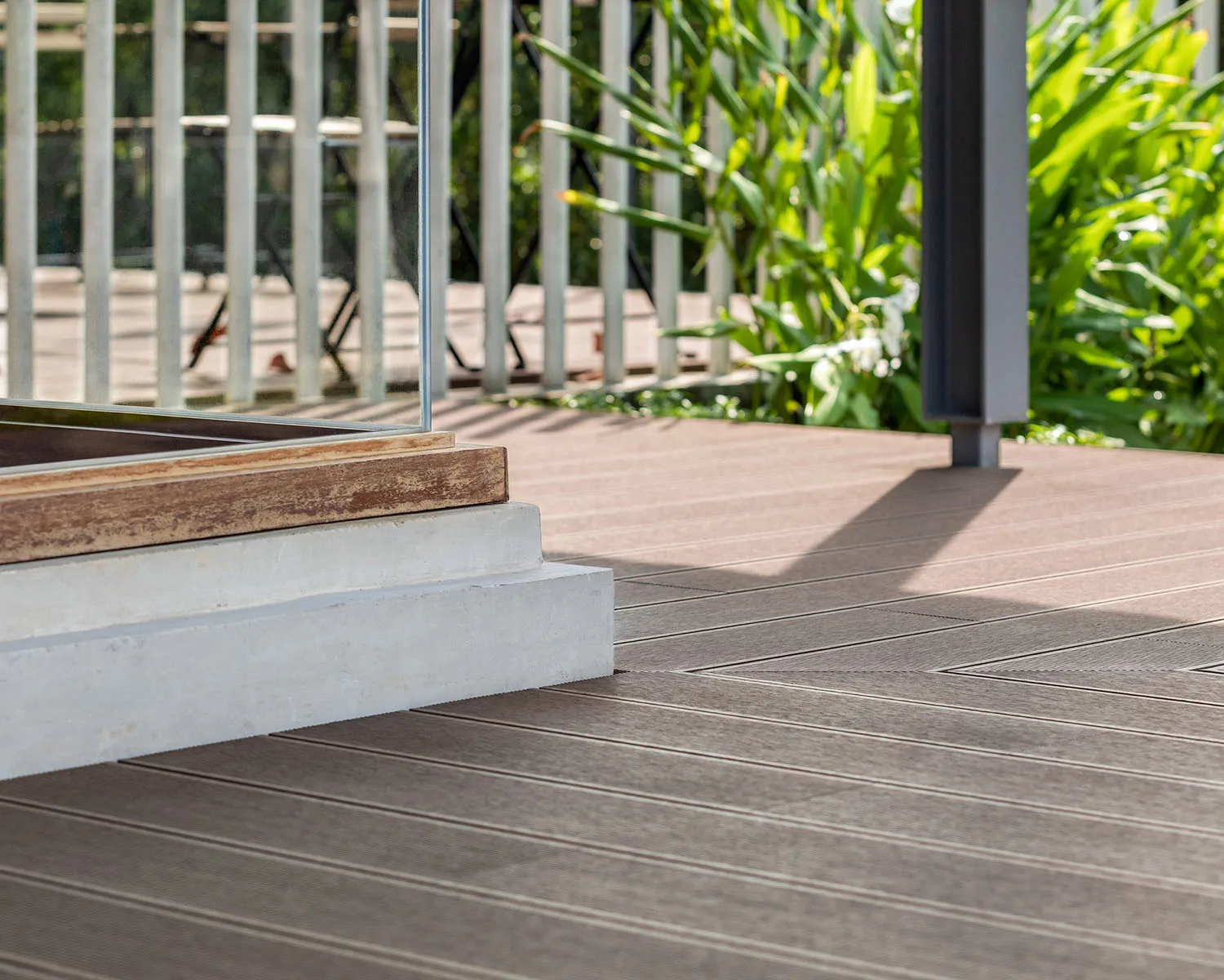 Wooden deck with two benches, well-lit by natural light, perfect for relaxation or socializing