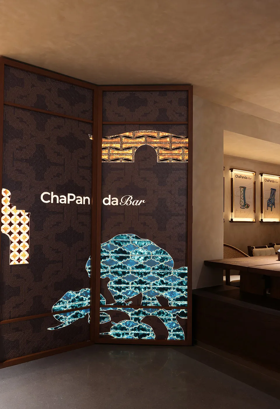 A modern restaurant bar area with a unique dragon-shaped doorway, a dining table, and chairs, creating a cozy atmosphere