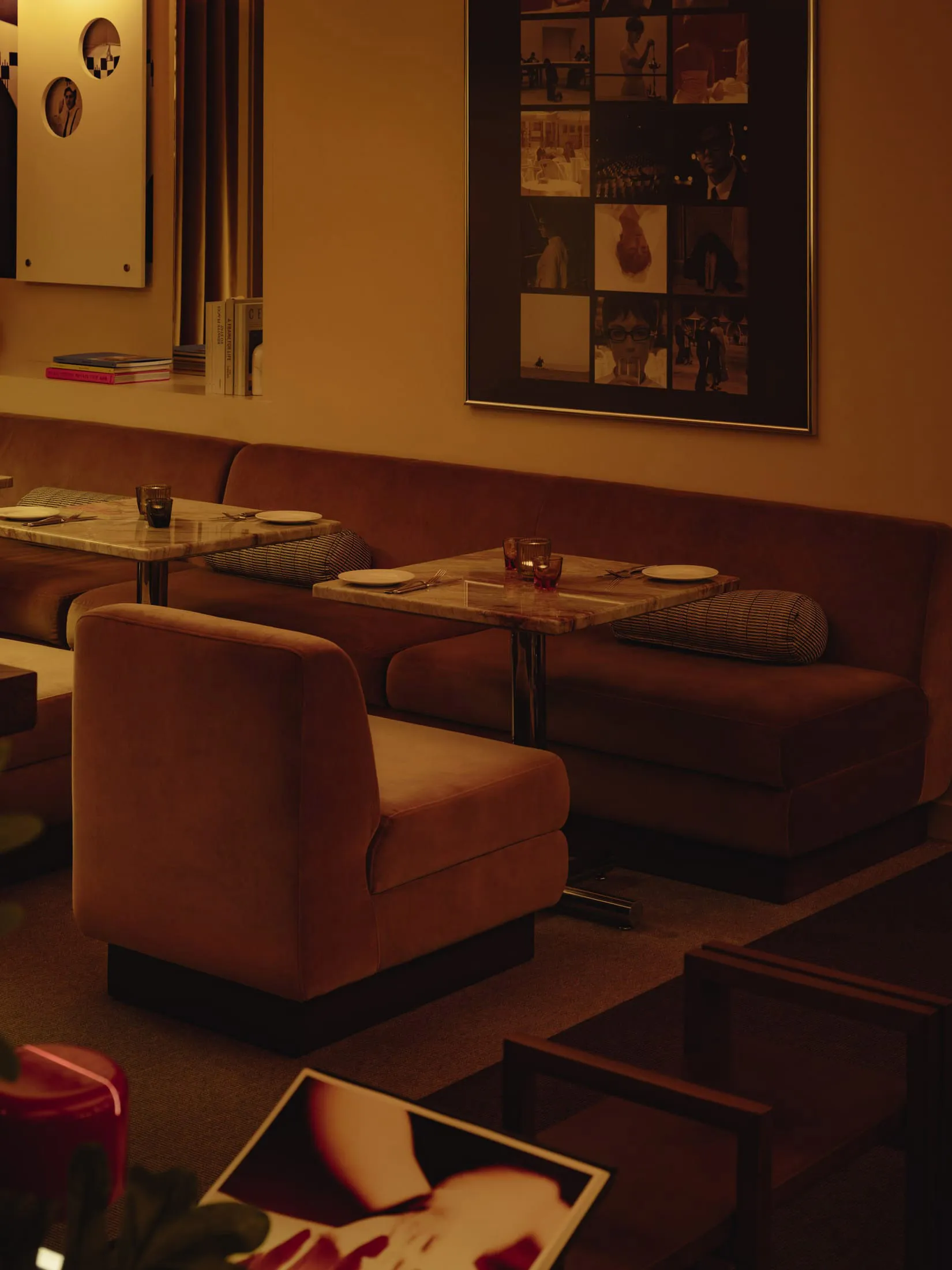 Cozy living space with brown couches and chairs arranged around dining tables, featuring cups and an inviting atmosphere