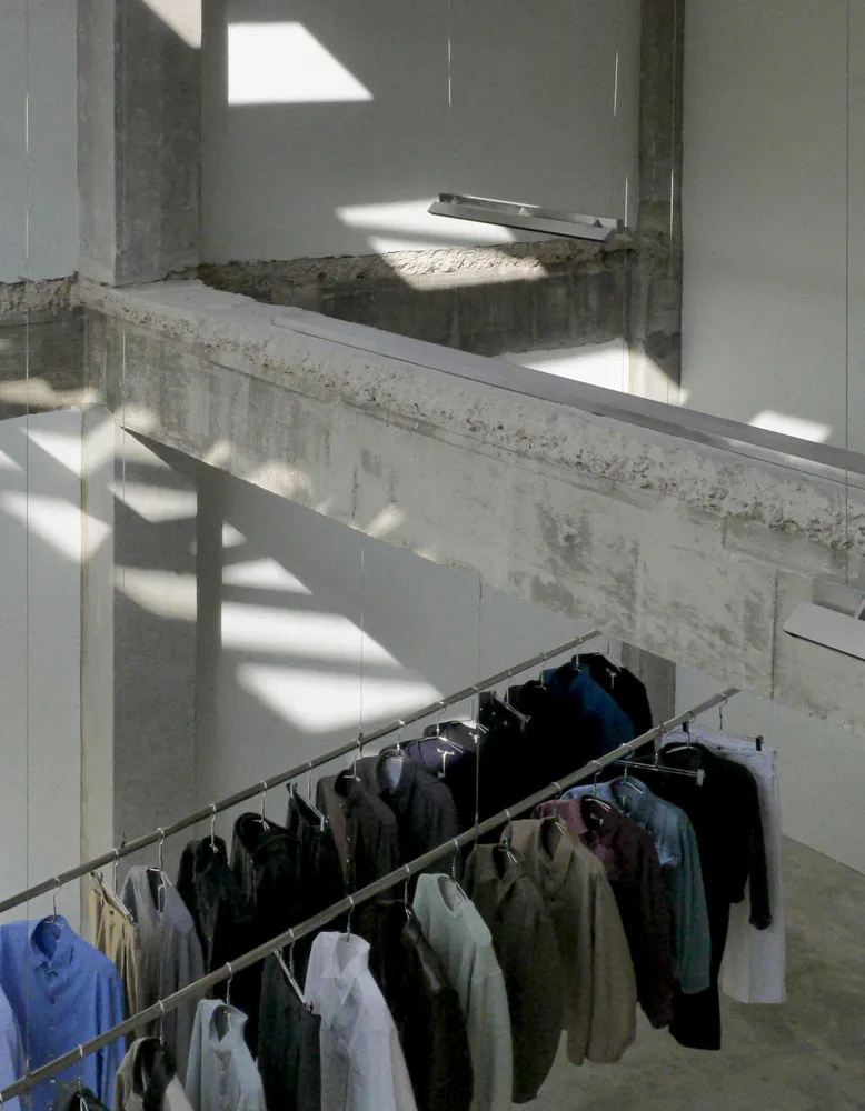 A well-organized wardrobe area with clothes in various sizes and colors hung on racks throughout the space