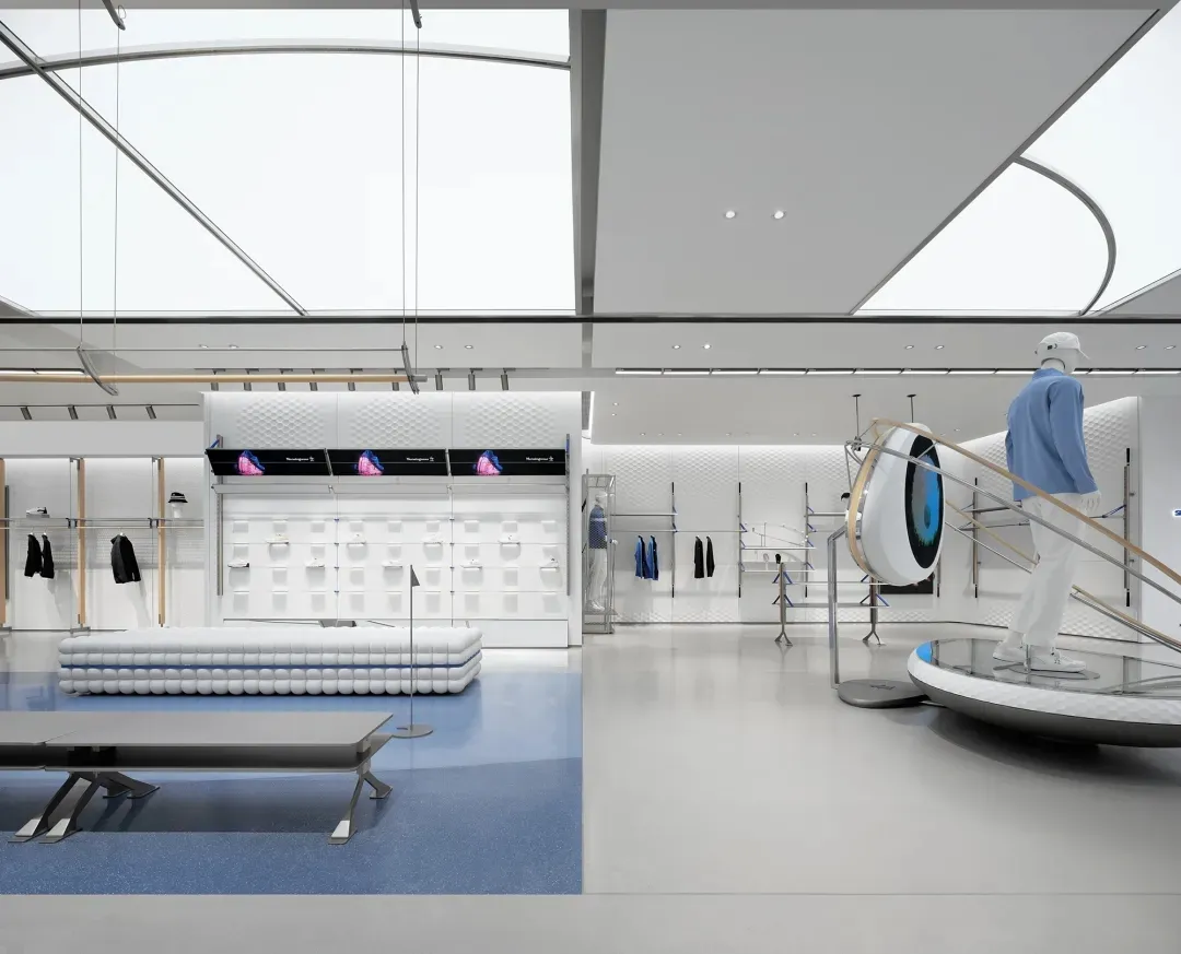 Open living space with natural light, a circular skateboard ramp, and modern furniture and decor