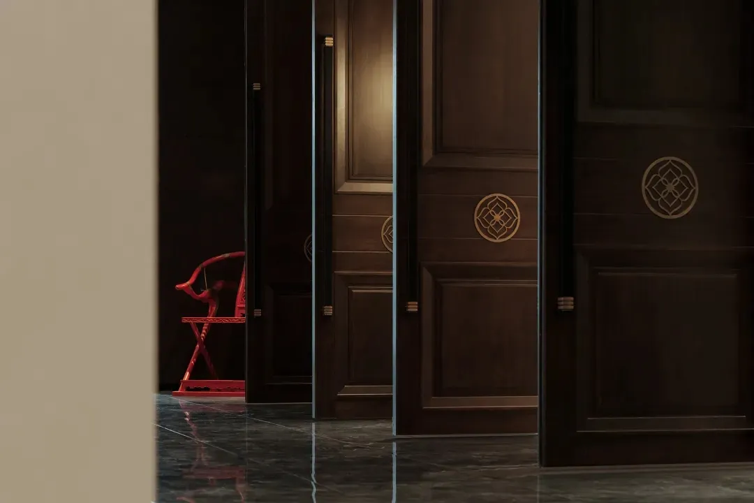 Wooden hallway with two chairs, doors on both sides, and a calm atmosphere