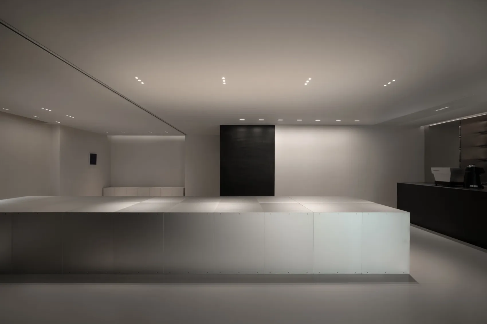 A large empty room with white walls and ceiling, giving a clean and minimalist appearance