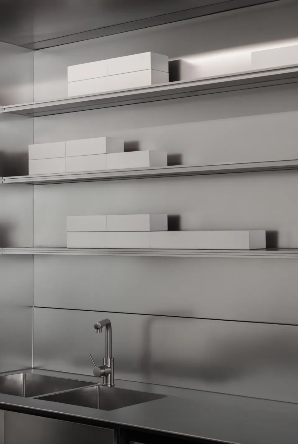 A silver metal shelf filled with boxes of varying sizes, placed on different levels, creating an organized and tidy appearance in a clean and well-maintained storage area