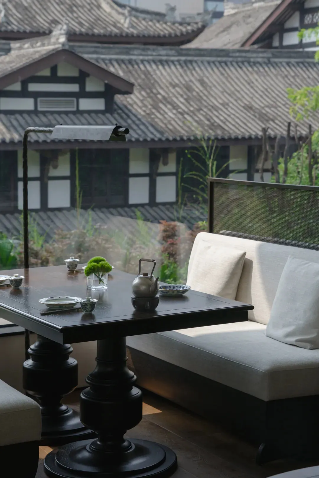 Cozy Asian-style living area with a dining table surrounded by chairs, two couches, and decorative items