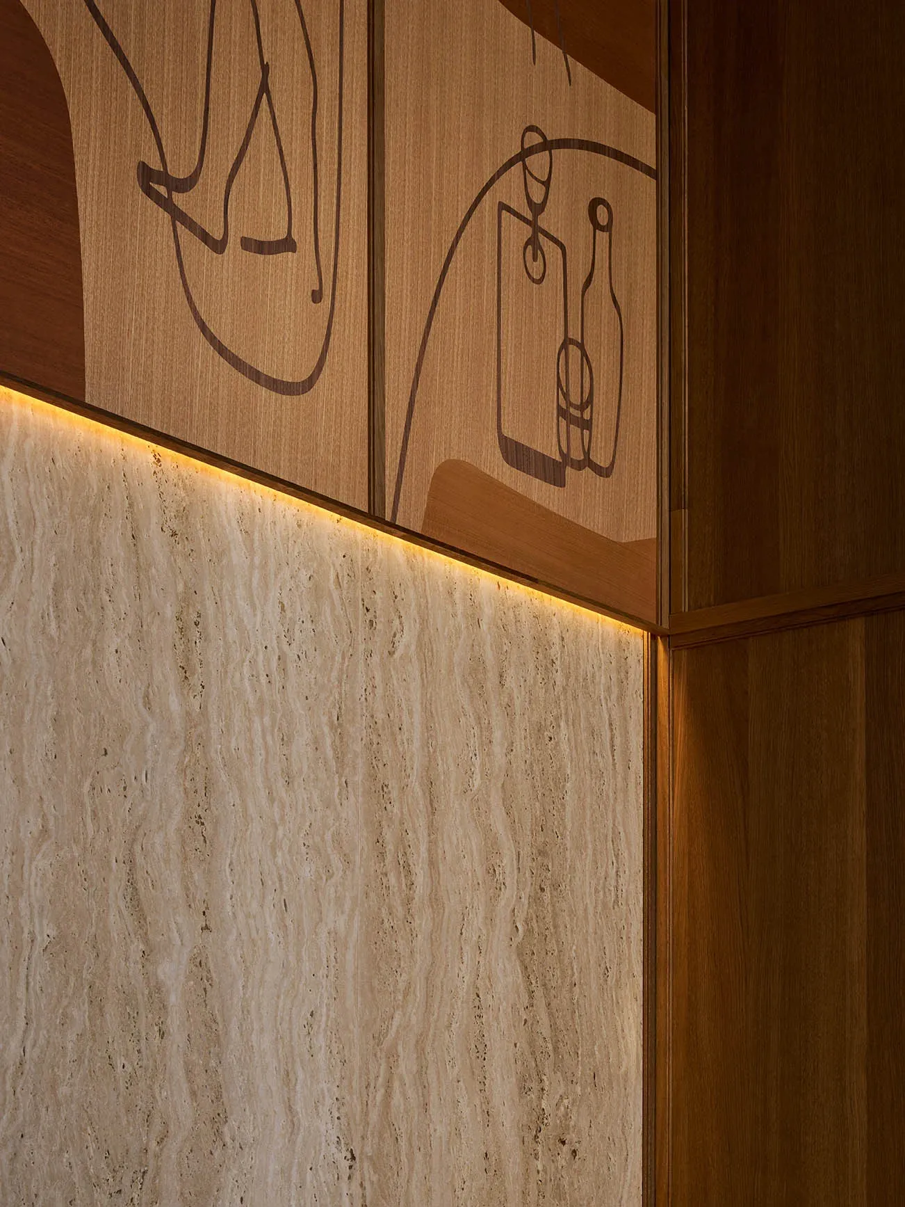 A stylish living area with a wooden wall featuring a wine glass carving and a bottle design, accompanied by three vases and decorative elements
