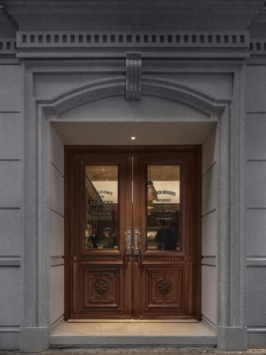 A welcoming restaurant entrance with a wooden door, people inside, and an inviting atmosphere