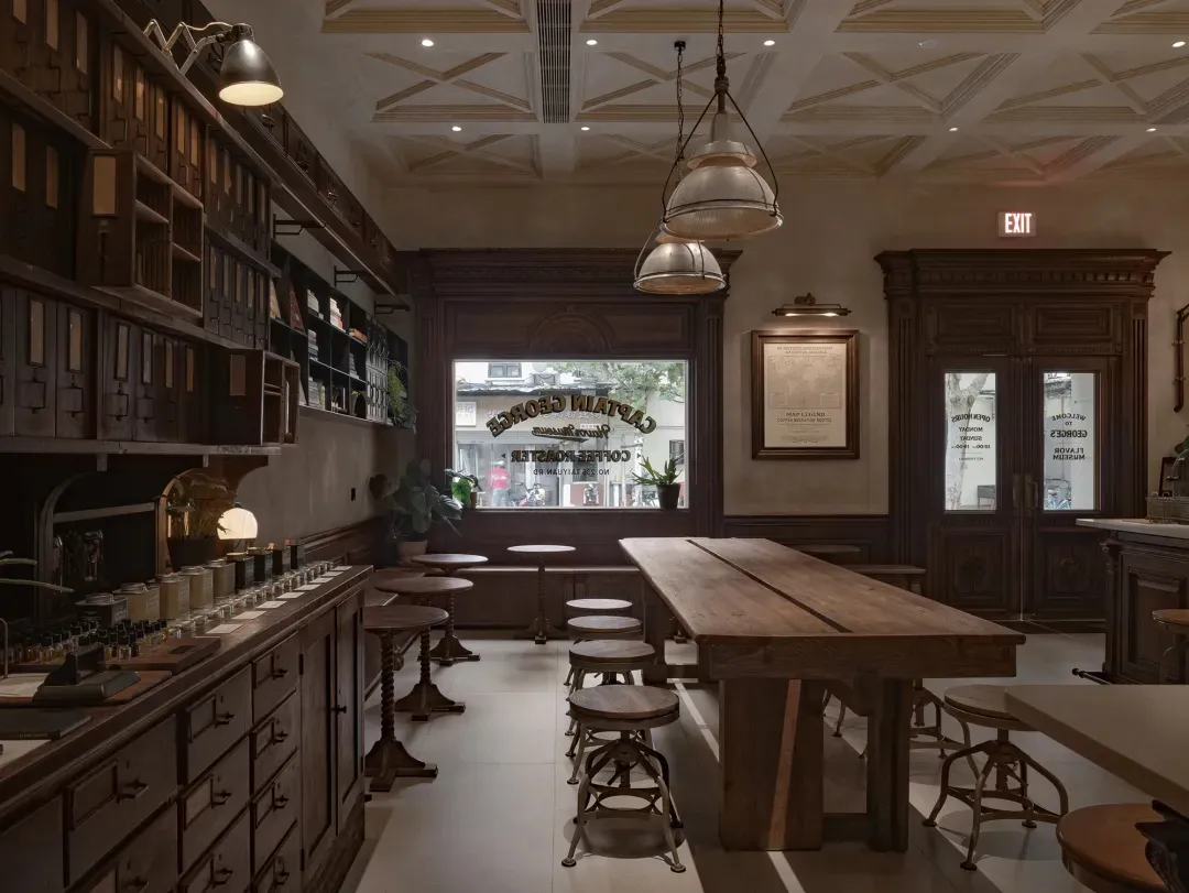 A warm and inviting bar area with a wooden table, chairs, and potted plants