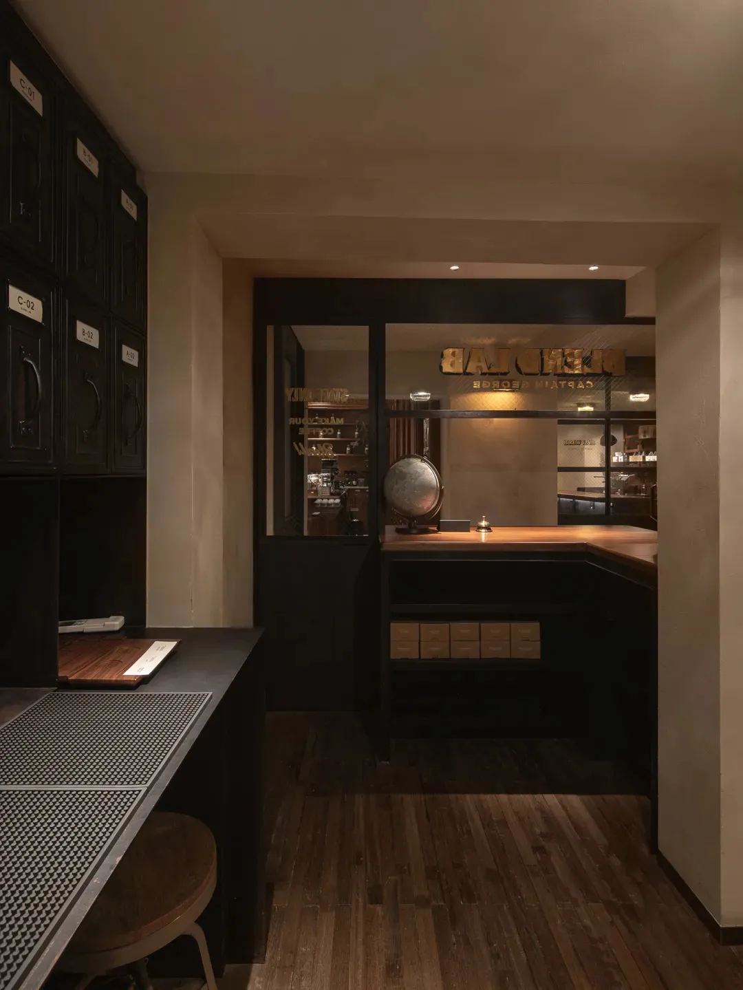 Cozy bakery interior with a counter, dining table, and comfortable seating, featuring a mix of rustic furniture and decorative items