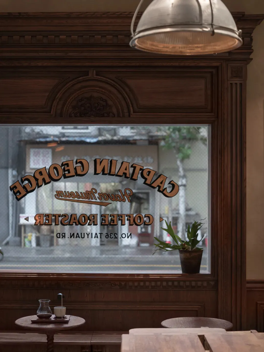 Warm and inviting coffee shop with wooden interior, natural light, potted plants, and vases