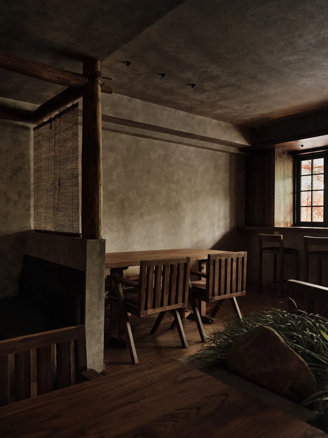 Dining area with wooden floors and walls, a large dining table, and several chairs, creating a warm and inviting atmosphere