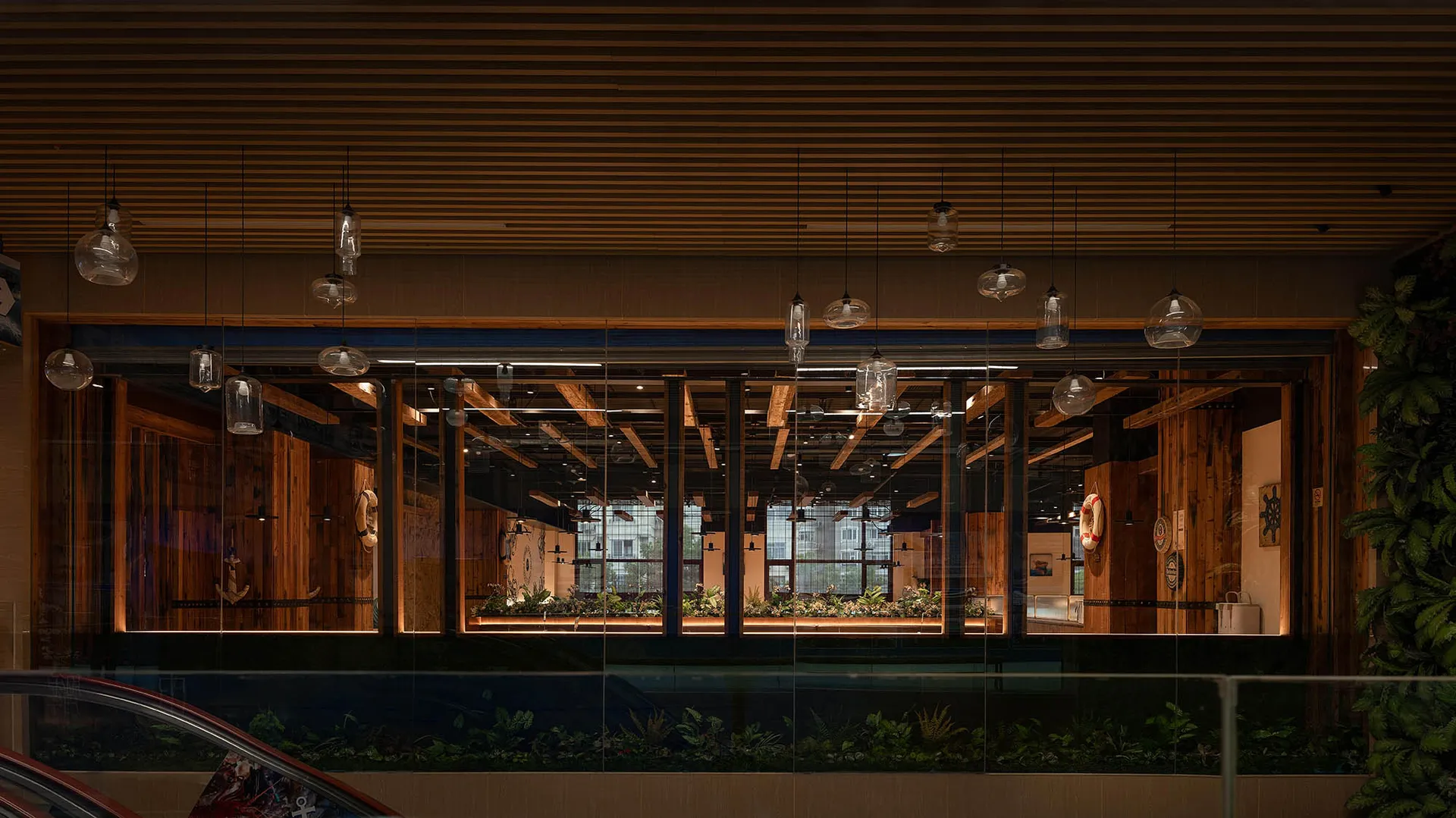 A bright and inviting indoor space with multiple windows, featuring various potted plants and two chairs, creating a natural atmosphere