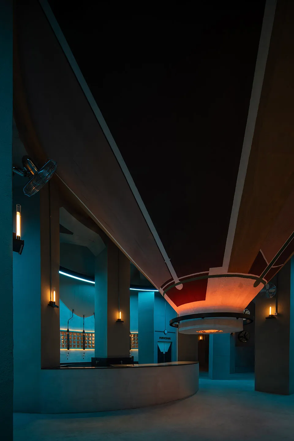Warm and inviting interior space with a large wooden ceiling beam, wooden planks, and multiple lights