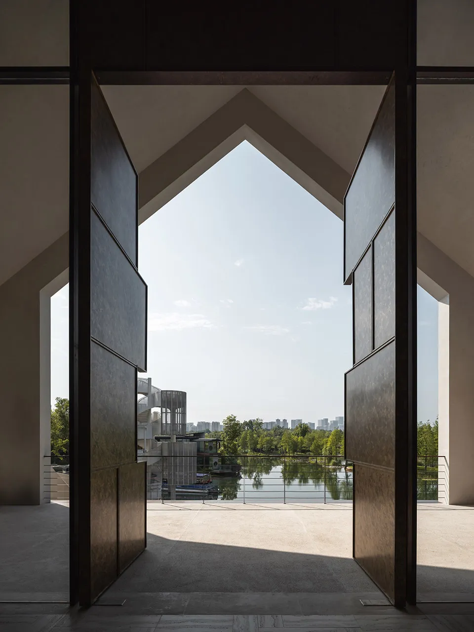 Architectural rendering of a building interior with a wooden door, boats, and natural light