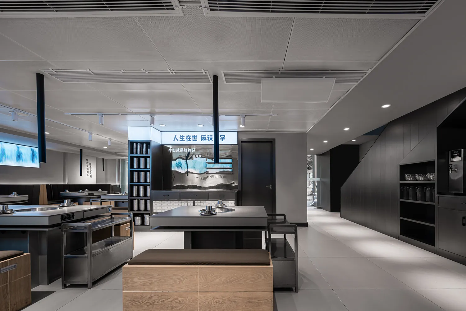 Modern showroom with various dining tables and chairs, white and grey walls, and a stylish atmosphere