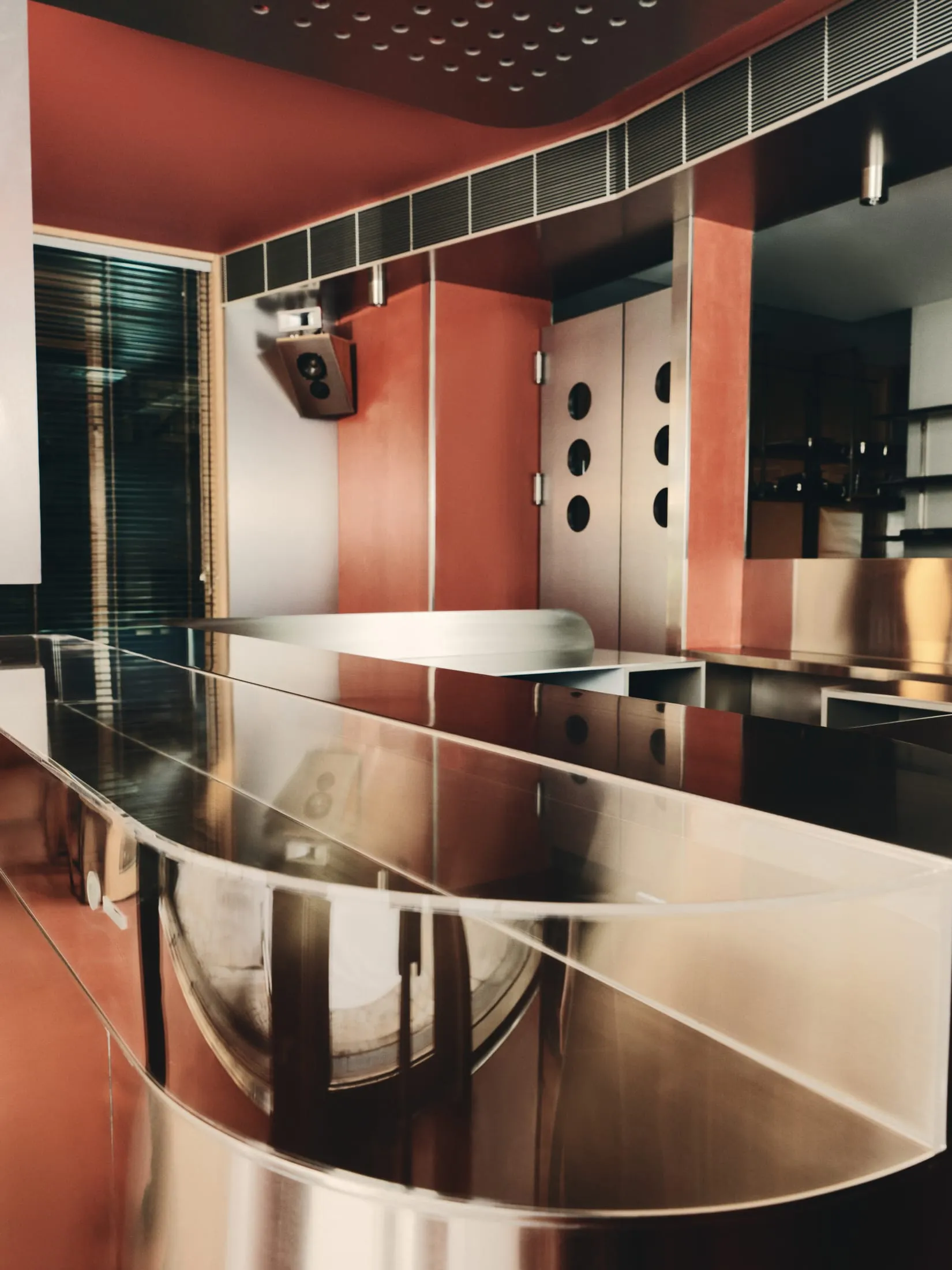 Modern kitchen with glass countertops, two sinks, and clean lines, creating a contemporary feel