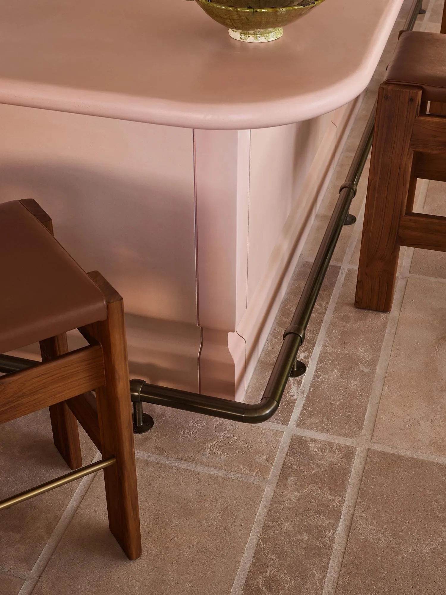 Bathroom with a pink countertop, two chairs, and a warm atmosphere