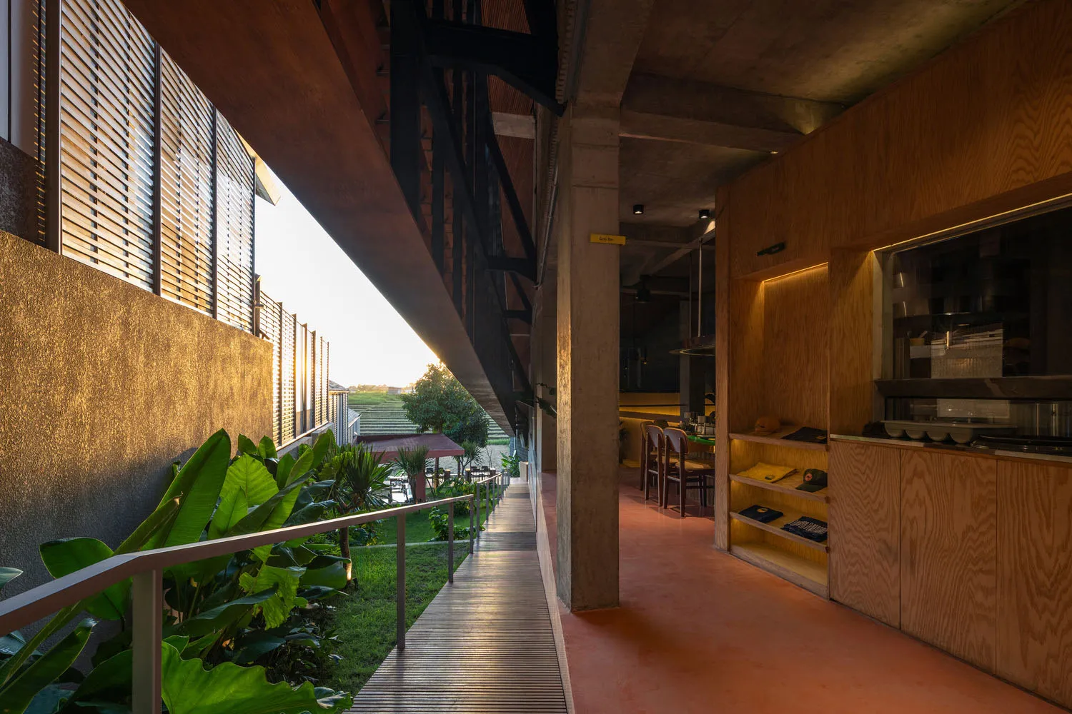 A pink interior space with natural light, comfortable seating, and dining tables, creating a warm and inviting atmosphere