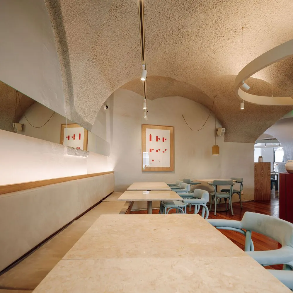 Calm and inviting restaurant interior with stone walls, wooden furniture, and a rustic atmosphere