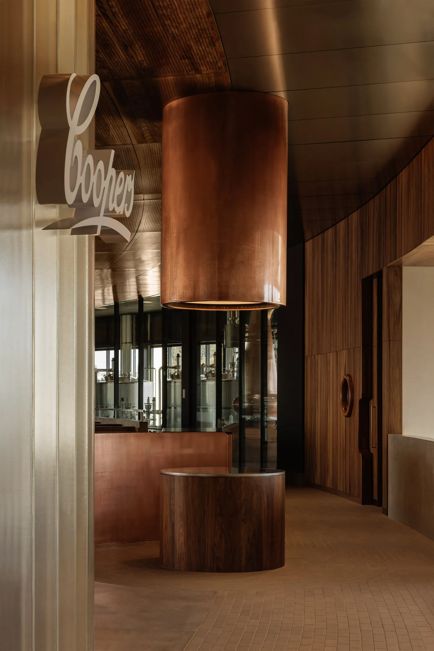 Warm and inviting interior design featuring a wooden bar area with a copper centerpiece and bottles on the countertop