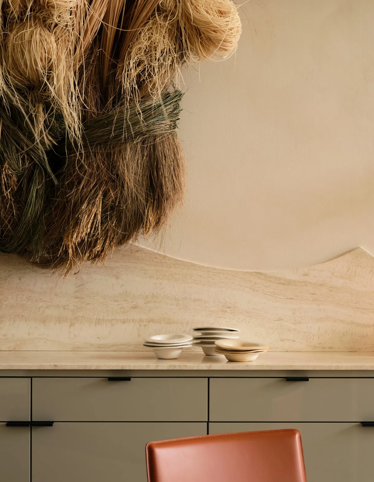 A clean and organized kitchen counter with bowls and cups on display, showcasing a focus on functionality and aesthetics