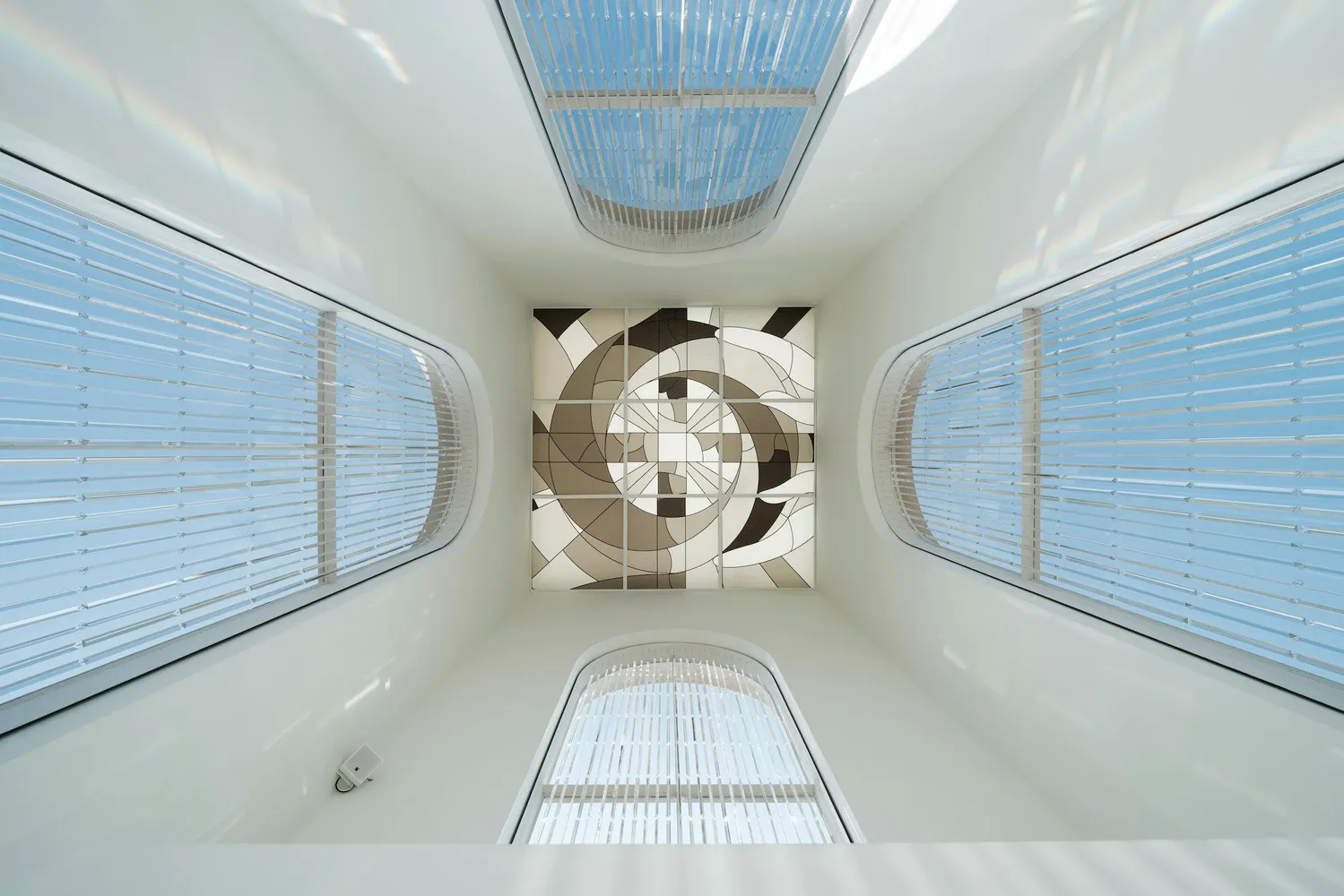 A bright and airy space with two prominent arches, large windows, and a minimalist appearance